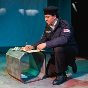 Navy sailor Davey sits writing a letter.