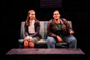 Two women sit beside each other in a car.